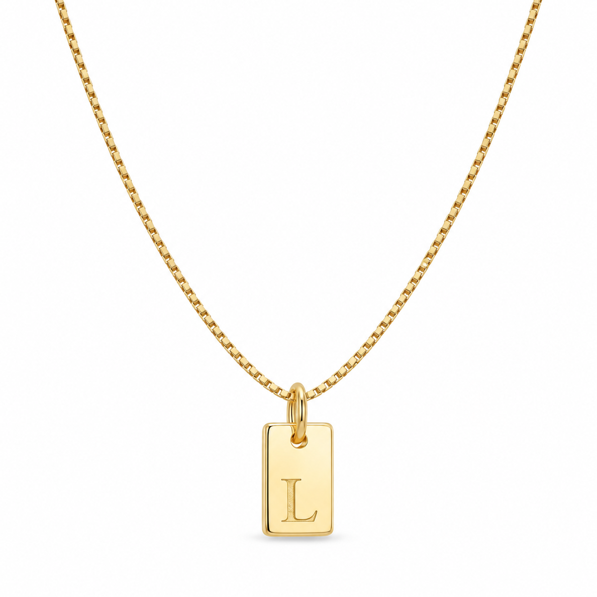 Gold initial tag necklace with a petite letter L pendant and fine box chain on a white background