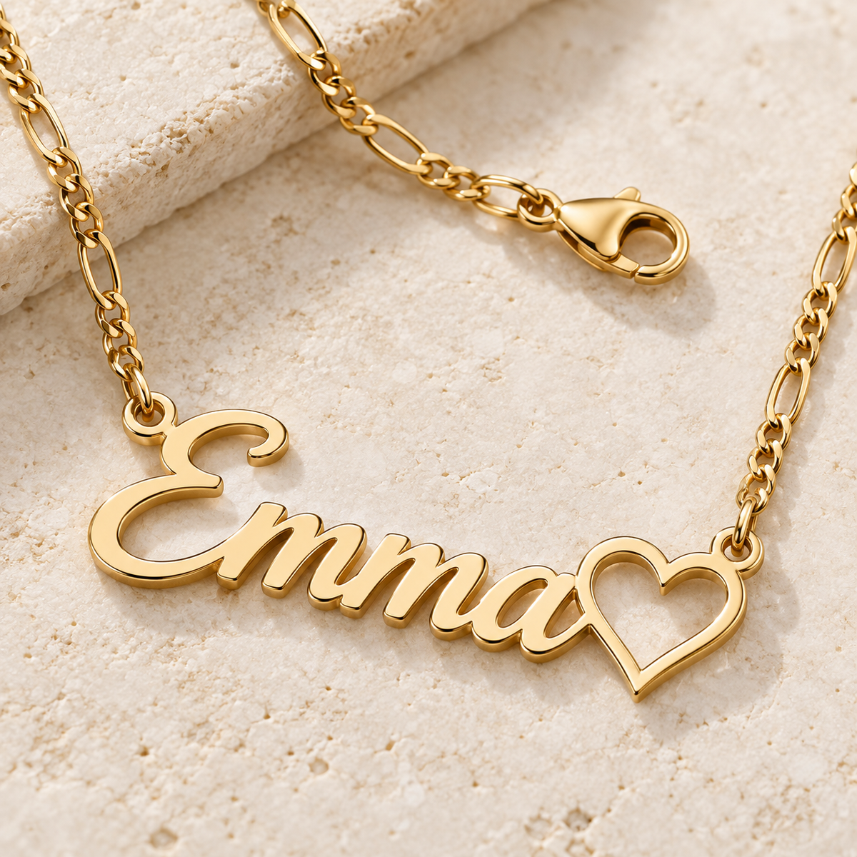 Close-up of a gold custom name necklace chain, connectors and lobster clasp